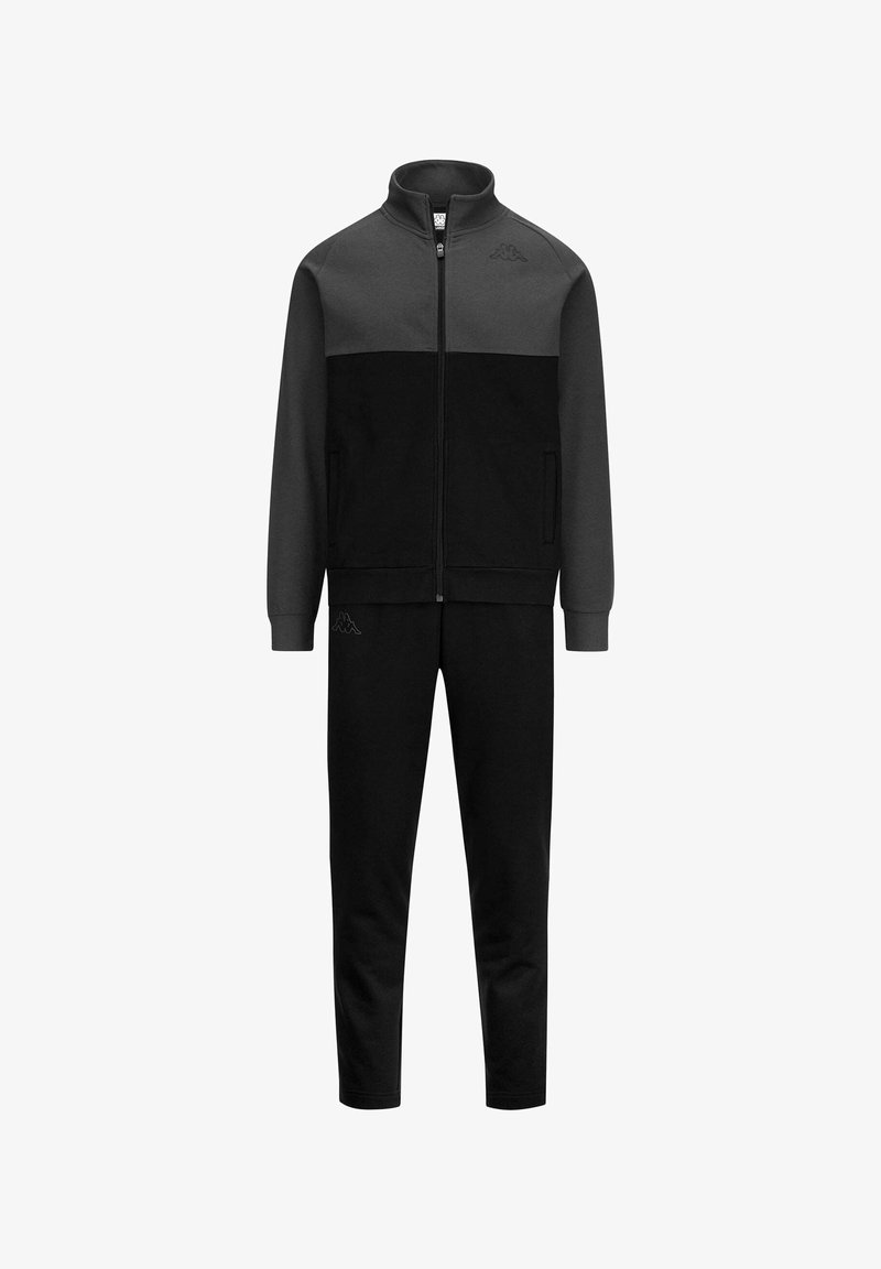 Tuta sportiva con giacca con zip in grigio scuro e nero, dotata di tasche laterali e pantaloni neri coordinati; realizzata in tessuto morbido.