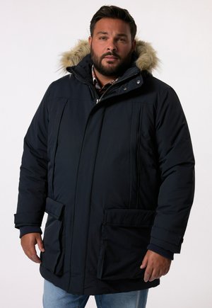 Mørkeblå polstret parka med en hætte kantet med pels, der har to frontlommer, lynlåslukning og en lige silhuet.