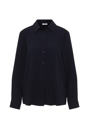 Chemise bleu marine à boutons avec un col, des manches longues et un tissu texturé présentant un motif froissé subtil. Six boutons à l'avant.