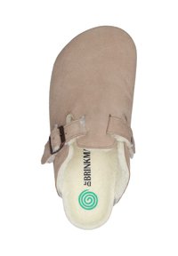 Beige suede clogs with a rounded toe and two adjustable straps. Soft fleece lining and a green spiral logo on the insole.