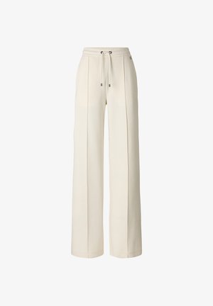 Krémově zbarvené široké kalhoty s elastickým pasem a šňůrkou, zdobené vertikálními švovými detaily na každé noze.