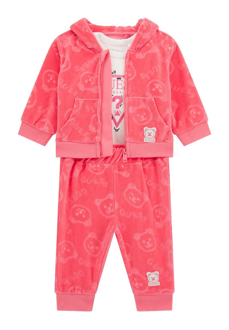 Completo due pezzi in peluche rosa, composto da una felpa con zip e motivo orsetto e pantaloni abbinati, entrambi dotati di polsini ed elastico in vita.