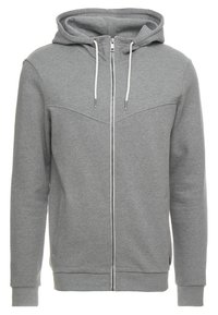 Felpa con zip grigia chiara, dotata di coulisse bianca, maniche lunghe e zip frontale, realizzata in tessuto morbido con vita e polsini aderenti.
