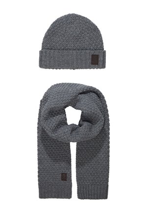 Gray knit beanie and scarf set, featuring a textured pattern, ribbed edges, and a small brown logo patch on each item.