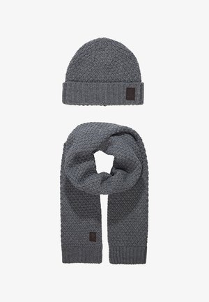 Gray knit beanie and scarf set, featuring a textured pattern, ribbed edges, and a small brown logo patch on each item.