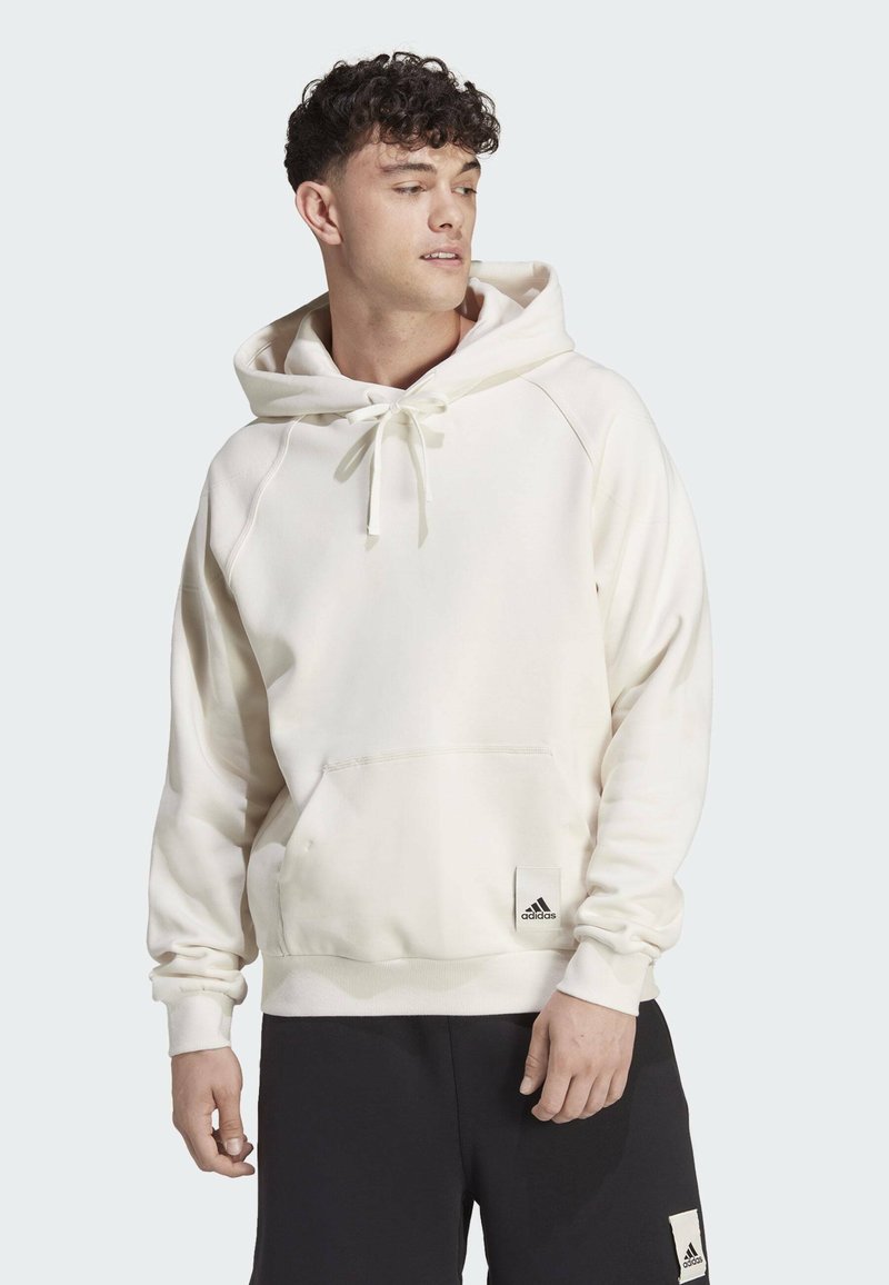 Felpa bianca con cappuccio e tasca anteriore, con coulisse e dettaglio del logo nero all'orlo. Tessuto morbido, vestibilità comoda.