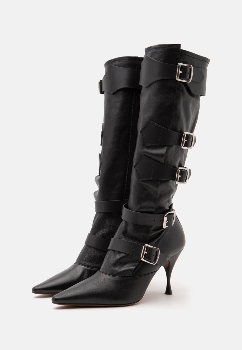 Black leather knee-high boots with pointed toes, slim heels, and five silver buckle straps on each boot.