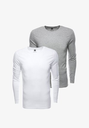 Due magliette a manica lunga, una bianca e una grigia, realizzate in cotone. Entrambe presentano scolli rotondi e maniche aderenti.