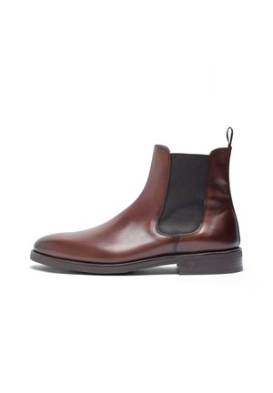 Braune Leder Chelsea-Stiefel mit elastischen Seitenpaneelen, abgerundeter Spitze und flacher Gummisohle. Mit Zuglasche hinten für einfaches An- und Ausziehen.