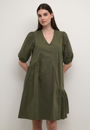 Olivgrön klänning med kort ärm och V-hals, rynkad bodice och utsvängd kjol. Tillverkad av lättviktsmaterial med subtil lyster.