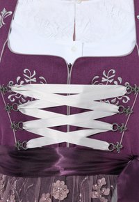 Paarse jurk met wit kanten lijfje, zilveren borduursels en satijnen veterlint. Voorzien van een donderpaarse satijnen tailleband en een versierde tule overlay.