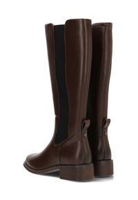 Botas de cuero marrón hasta la rodilla con paneles laterales elásticos y punta redonda. Presentan un tacón bajo y una tira en la parte posterior para facilitar su uso.