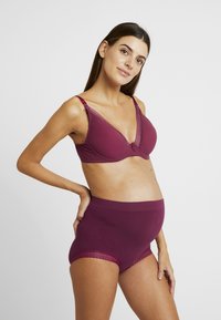 Maternity bra and high-waisted briefs in deep burgundy. Soft, stretchy material with lace trim on the bra and leg openings of the briefs.