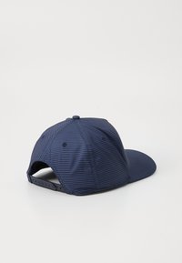 Navy blue cap with a striped design, made of fabric with a smooth texture. Features a curved brim and an adjustable snapback closure.