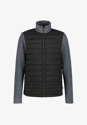 Zwarte gewatteerde vest met grijze gebreide mouwen. Bevat een hoge kraag en een ritssluiting aan de voorkant. Zijzakken zijn geïntegreerd in het ontwerp.