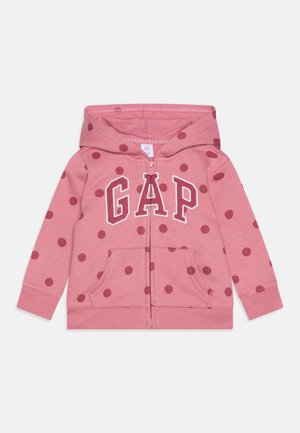 Sweat à capuche zippé rose pour enfants avec des pois rose foncé, poches avant, une capuche et lettrage du logo GAP sur la poitrine.