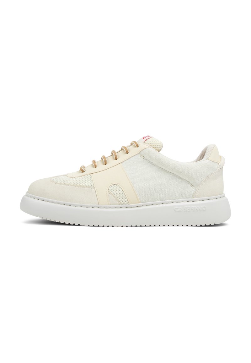 Beige sneakers with a textured upper, mesh accents, and contrasting white sole. Features beige laces and subtle branding on the heel.