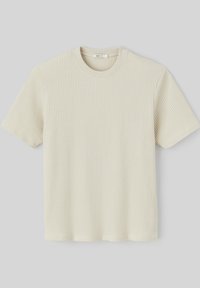 T-shirt à manches courtes de couleur crème fabriqué en tissu côtelé. Présente un col rond et une coupe droite à l'ourlet.