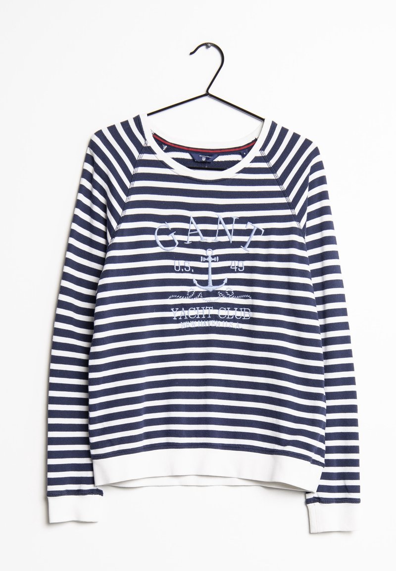 Sweatshirt rayé bleu marine et blanc avec un col rond, des manches raglan, et des poignets blancs ; présente un texte brodé et des motifs nautiques.