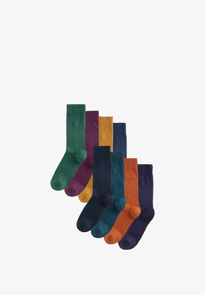 Mischung von Socken in acht Paaren in verschiedenen Farben: grün, lila, gelb, dunkelblau, teal, orange und dunkelmarine. Hergestellt aus strukturiertem Material.