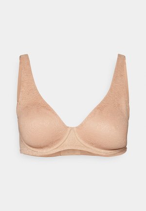 Lace bralette in nude color, with molded cups and wide straps. Smooth texture, featuring floral lace pattern over the fabric.