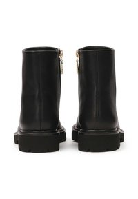 Black leather ankle boots with a smooth texture, rounded toe, chunky rubber sole, and gold-tone zip closures on the back.