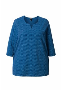 Túnica azul con un patrón de espiga, con escote en V y mangas tres cuartos. Fabricada con una tela suave y ligera.