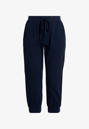 Pantalon de jogging bleu marine en tissu doux. Il est doté d'une ceinture élastique avec cordon de serrage et de chevilles resserrées pour une coupe décontractée.