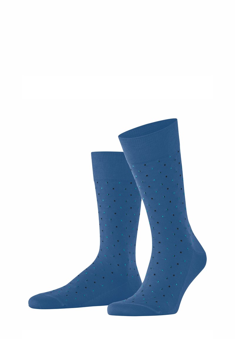 Blaue Socken mit gerippten Bündchen, die ein gepunktetes Muster in Schwarz und Türkis aufweisen. Glatte Textur, knöchellang.