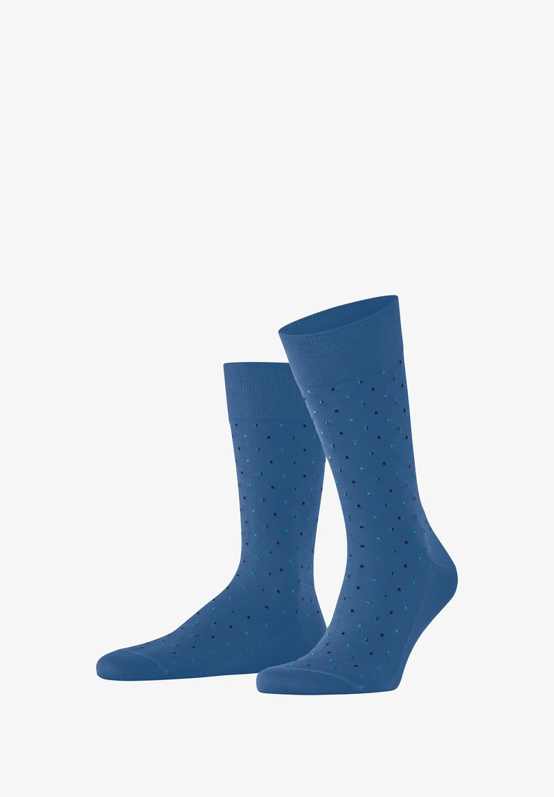 Niebieskie skarpetki z prążkowanymi mankietami, ozdobione wzorem w kropki w kolorze czarnym i teal. Gładka tekstura, długość do połowy łydki.