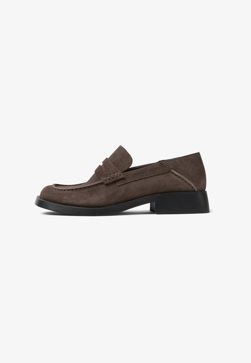 Brown suede loafer with a low, black heel. Features a raised, stitched detail on the vamp. Rounded toe and smooth texture throughout.