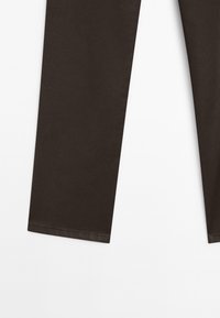 Dark brown pants made of cotton fabric, featuring straight legs and simple stitching details. Smooth texture with no visible patterns.