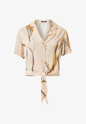 Blusa a maniche corte di un leggero beige, con bottone frontale, orlo annodato e motivi astratti in oro e nero. Tessuto morbido e liscio.