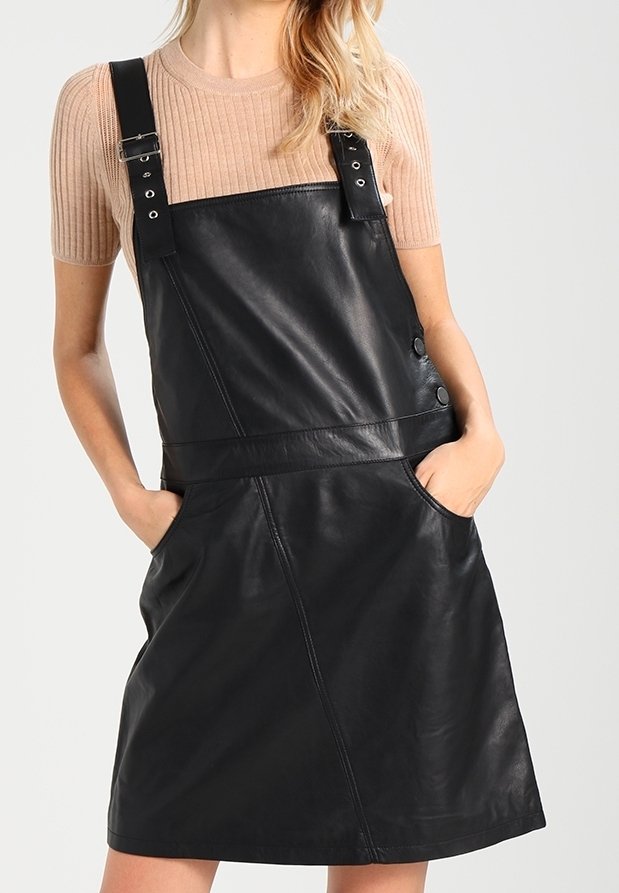 Zwarte leren overall jurk met verstelbare banden, knoopaccenten en zijzakken. Geverfde afwerking en een getailleerde taille.