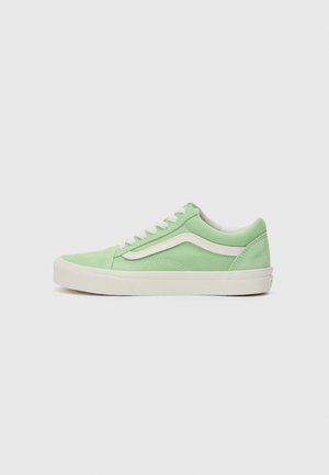 Green suede sneakers with a white leather stripe, round toe, white laces, and a light rubber sole. Side view on a plain background.