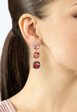 Dangle earrings with three stacked gemstones: a light pink top stone, a red octagonal middle, and a dark red square bottom, each framed in silver.
