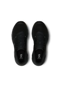 Black athletic shoes with a breathable mesh upper, padded tongue, and laces, featuring a cushioned sole and logo detail on the insole.