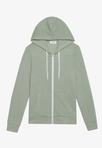 Sudadera con cremallera de color verde claro, con capucha, cordones blancos, bolsillos laterales y puños acanalados. Está hecha de una suave mezcla de algodón.