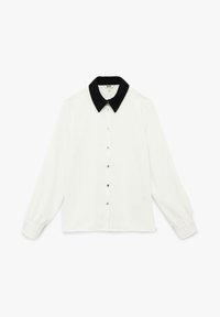 Camisa de manga larga blanca con cuello negro, presenta cierre de botones y tejido suave. Incluye botones en tono dorado a lo largo del frente.