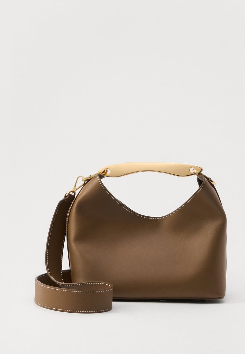 Brown leather handbag with a cream top handle, featuring a rounded shape, adjustable strap, and visible stitching detail.