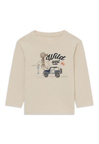 Bež pikkhargiga särk, millel on sinise jeepli, tuulegeneraatori, kaktuste ja musta tekstiga "Wild West traveller" illustreerimine.