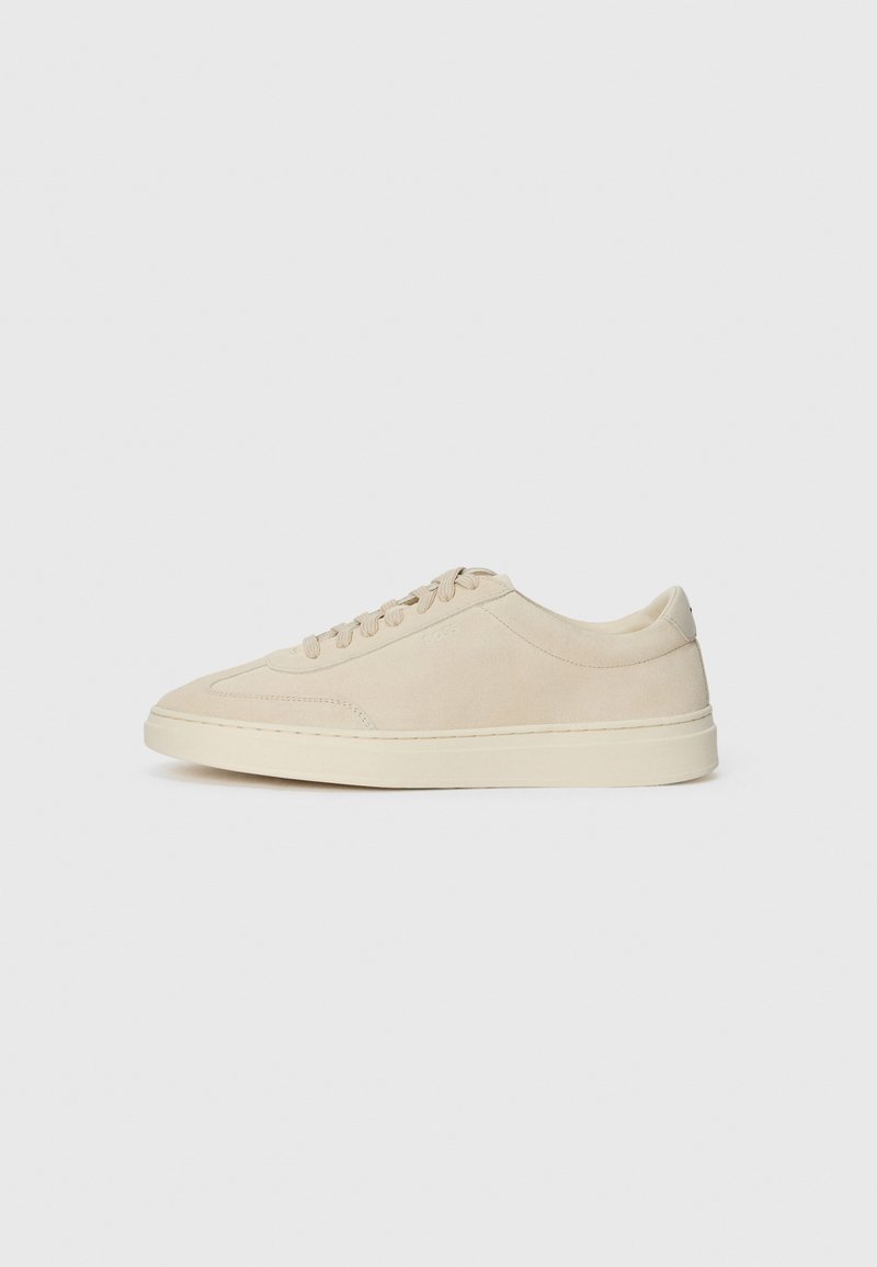 Beige suede low-top sneaker with laces, round toe, and a thick rubber sole, shown in right side profile on a white background.