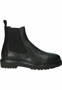 Botín Chelsea de cuero negro con paneles laterales elásticos, punta redondeada y suela rugged. El diseño incluye una asa para facilitar la puesta.