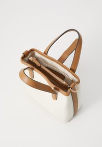 Small rectangular handbag in canvas with brown leather accents. Features two handles, a zipper closure, and an interior pocket.