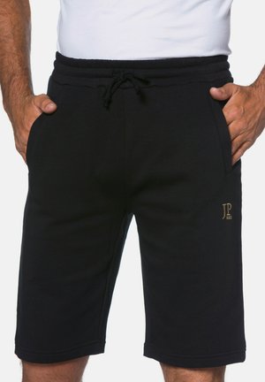 Black athletic shorts made of soft material with an elastic waistband and drawstring, featuring side pockets and a gold logo accent.