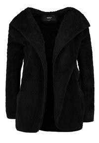 Mustassa pörröisessä takissa on leveä kaulus, avoin etuosa ja kaksi sivutaskua. Pehmeä rakenne, rento istuvuus ja ei näkyviä kiinnityksiä.