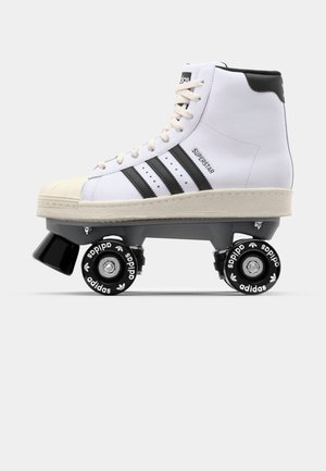 White roller skate with three black stripes, rubberized gray base, black wheels featuring white logo, and signature rubber toe cap design.