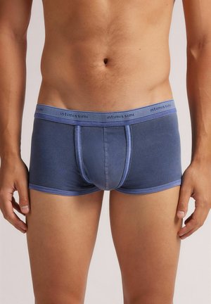Men's blue trunk underwear made from soft fabric, featuring a contrasting light blue waistband with printed brand name, and a snug fit design.