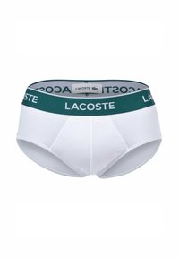 Boxers pour hommes en coton blanc avec une ceinture élastique verte portant le logo "LACOSTE". Coupe classique, texture lisse et design ajusté.