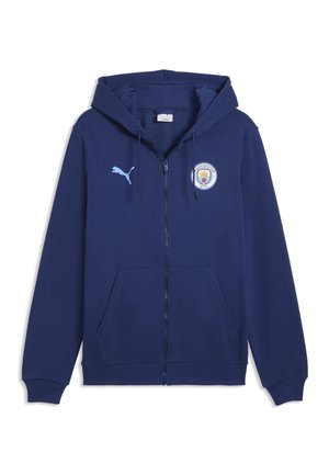 Granatowa bluza z kapturem i zamkiem błyskawicznym, przednimi kieszeniami, logo Puma na prawej piersi oraz herbem klubu piłkarskiego Manchester City na lewej piersi.